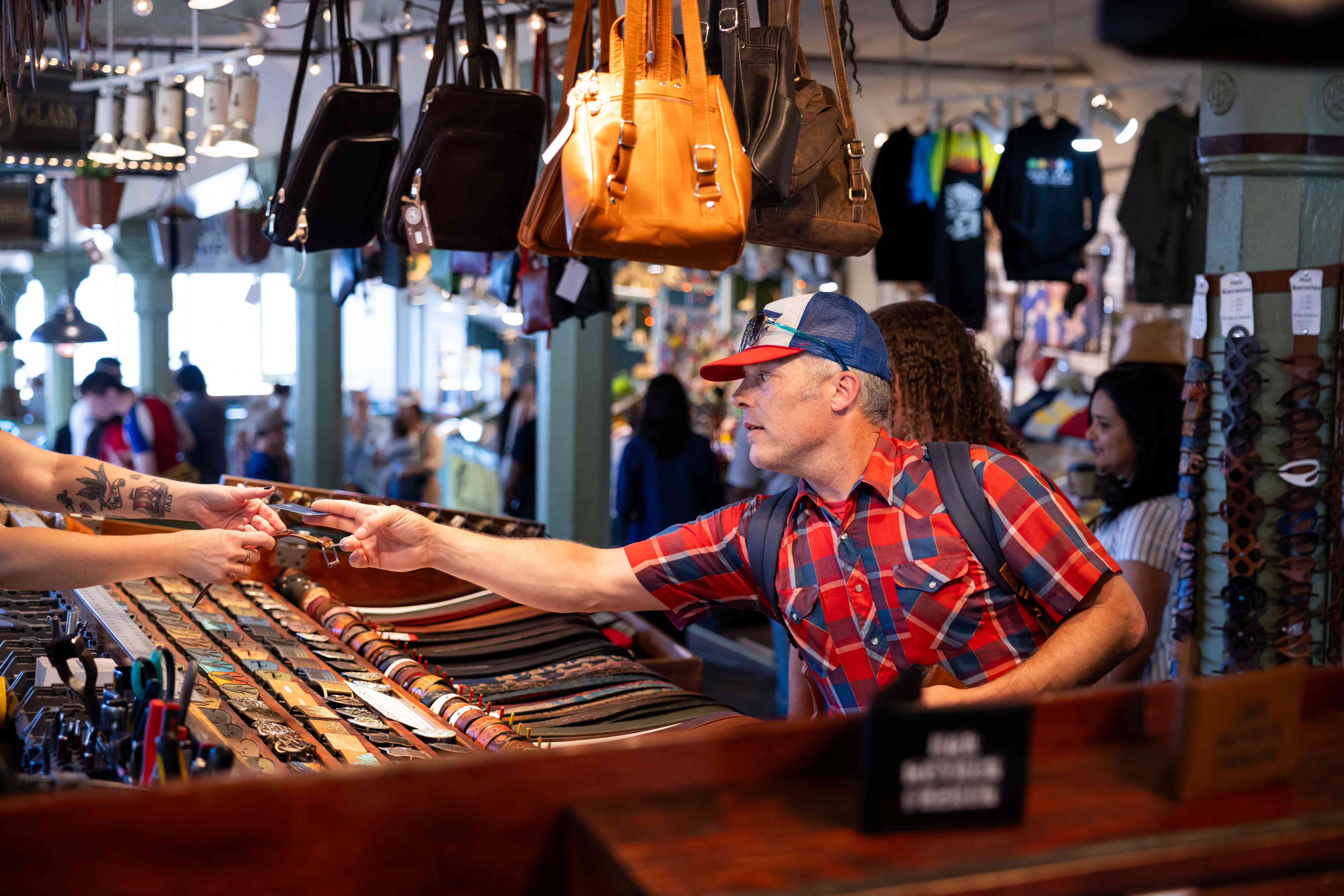 A man uses a credit card at the Pike Place Market in Seattle.